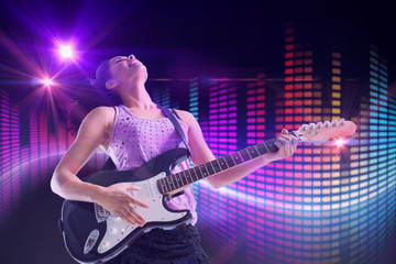 Obraz na płótnie Canvas Pretty girl playing guitar against digitally generated disco light design