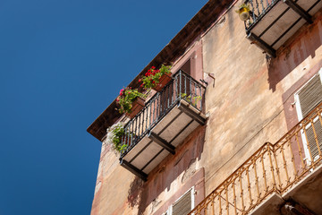 Fototapeta na wymiar Old house with flowers on a balcony