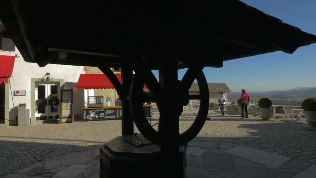 A wooden well in a courtyard