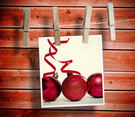 Photo hanging from line against wooden background