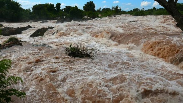 Southeast Asia&rsquo;s largest Waterfalls, the Khone falls. At the end of the rainy season the falls are most impressive as the Mekong River is swollen with rain water turned brown by sediments.