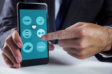 Businessman using smartphone against fitness apps