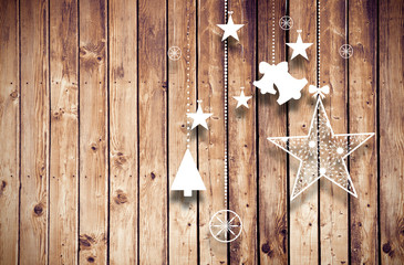 Hanging christmas decorations against wooden planks background