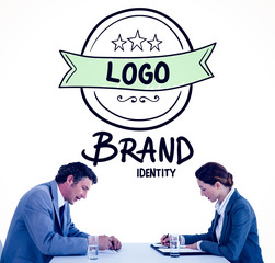 Business people brainstorming together against brand identity doodle