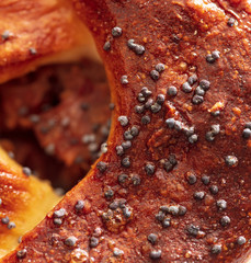 Poppy seeds in a bun as a background