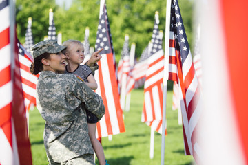American Female soldier with a little girl