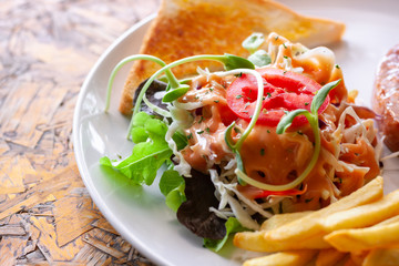 Vegetable salad with french fries and sliced  bread