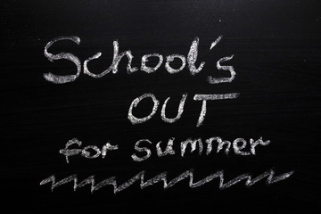 School`s out for summer text on chalkboard