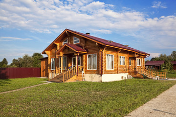 Fototapeta na wymiar rural wooden house with grass lawn around