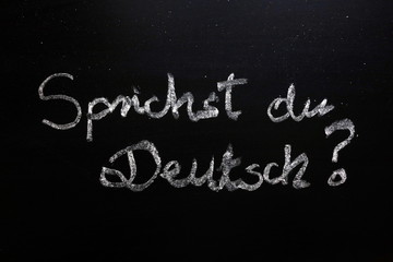 Fototapeta na wymiar Sprichst du Deutsch (do you speak German) question written on chalkboard