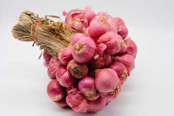 Close up and top view: Group of fresh red onions isolated on white background.