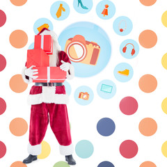 Santa carrying gifts against colorful polka dot pattern 