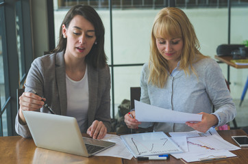 two attractive colleague business woman adviser working with teamwork together discussion planning to complete and successful project.
