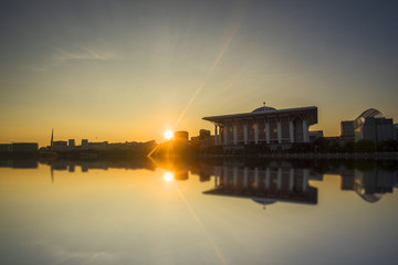 Scenery of Sunrise at Sultan Mizan Mosque,Putrajaya with clear blue sky and reflection. soft focus,blur due to long exposure. visible noise due to high ISO.