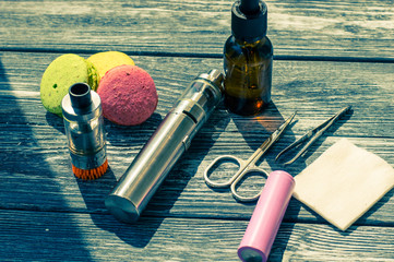 Still life with e-cig and jiuce on the wooden background