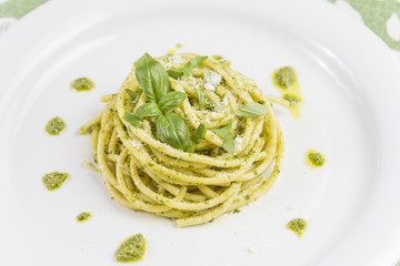 Spaghetti pasta Bucatini with pesto sauce and parmesan from wild garlic in white dish