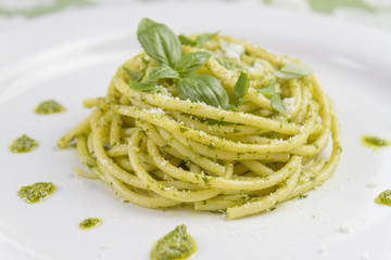 Spaghetti pasta Bucatini with pesto sauce and parmesan from wild garlic in white dish