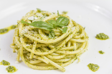 Spaghetti pasta Bucatini with pesto sauce and parmesan from wild garlic in white dish