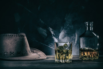  Glass of whiske and decanter with cowboy hat