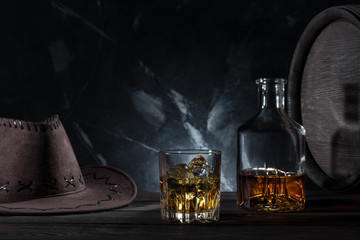 Transparent glass with whiskey cowboy hat and decanter