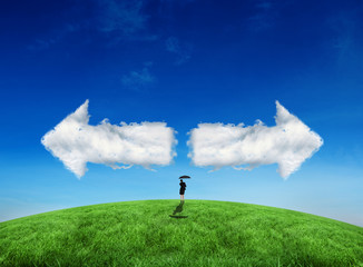 Composite image of young businesswoman holding umbrella against cloud arrows