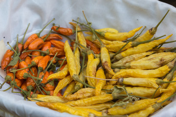 Orange and Yellow Dried Chili Peppers inside White Bowl