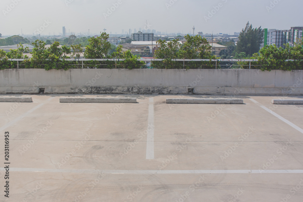 Wall mural empty space of car parking lot on rooftop floor of buildings. (selective focus)