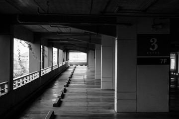 Abstract Black and White image rows of empty space car parking lot. (Selective focus)
