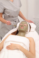Obraz na płótnie Canvas facial treatment of young woman in a cosmetology salon