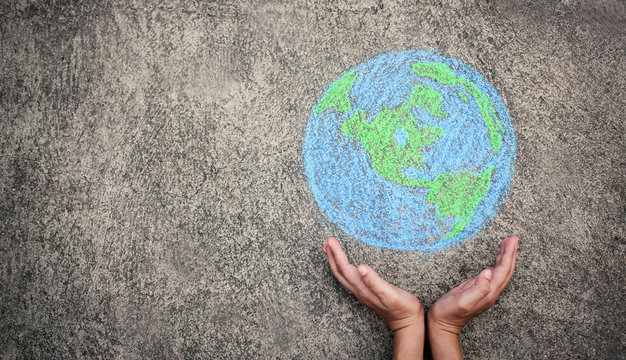 Closeup hands holding earth draw with chalk. World harmony green peace environment earth day together concept banner.