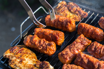 Close up pf delicious chicken breast on wooden skew with fresh vegetables, garlic, paprika fried on mangal barbeque grill
