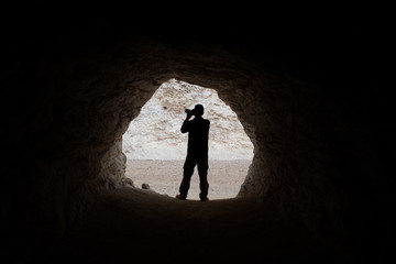 Fototapeta premium young photographer making photos in a cave