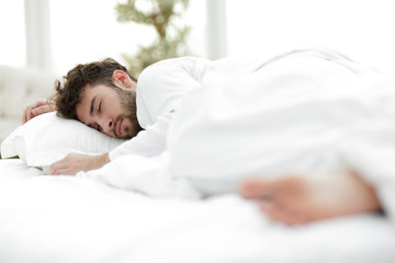 closeup.the tired men sleep soundly on the bed