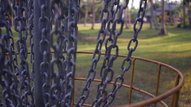Hit the disc in the basket for frisbee golf. slow motion. 1920x1080. full hd