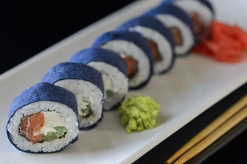 sushi rolls on a black background