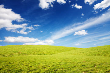 Grassy hills under amazing sky background