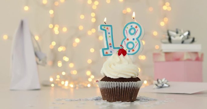 Happy Eighteenth number 18 candle Birthday Cupcake blurred garland lights background