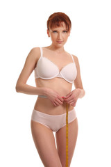 Fototapeta premium girl doing body measurements with measuring tape