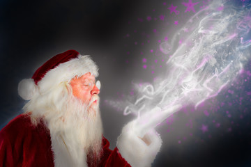 Santa claus blowing against blurred snowflake design