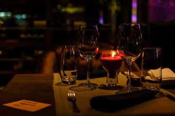 Two wine glasses and defocused lights at the restaurant