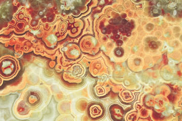 Texture pattern for tiles. Surface of an onyx plate. The texture of kind of agate stone. Circular stains on structure of stone. 