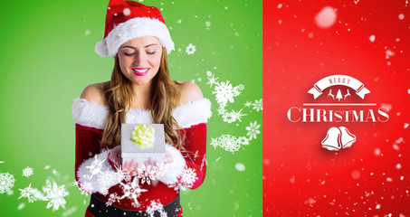 pretty girl in santa costume holding gift box against red vignette