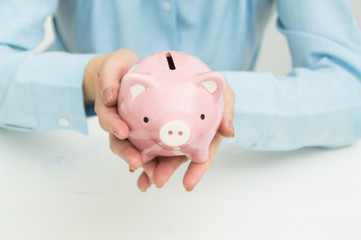 Women are collecting money in a piggy bank.