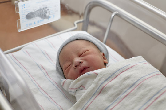 A New Born Infant In A Hospital Crib