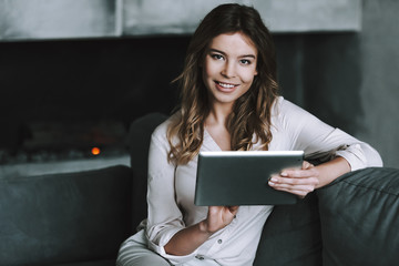 Young woman with tablet talking on phone.