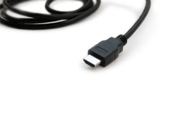 Black HDMI cable on white background. Connector close-up.