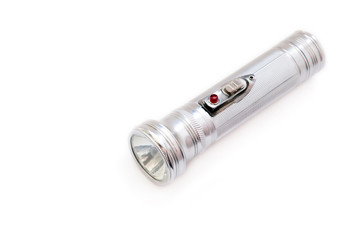 Small electric metal flashlight with incandescent bulb on white background. Hand-held portable lamp.