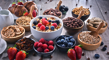 Different sorts of breakfast cereal products and fresh fruits
