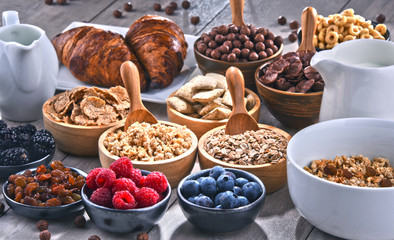 Different sorts of breakfast cereal products and fresh fruits - obrazy, fototapety, plakaty