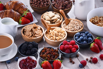 Different sorts of breakfast cereal products and fresh fruits